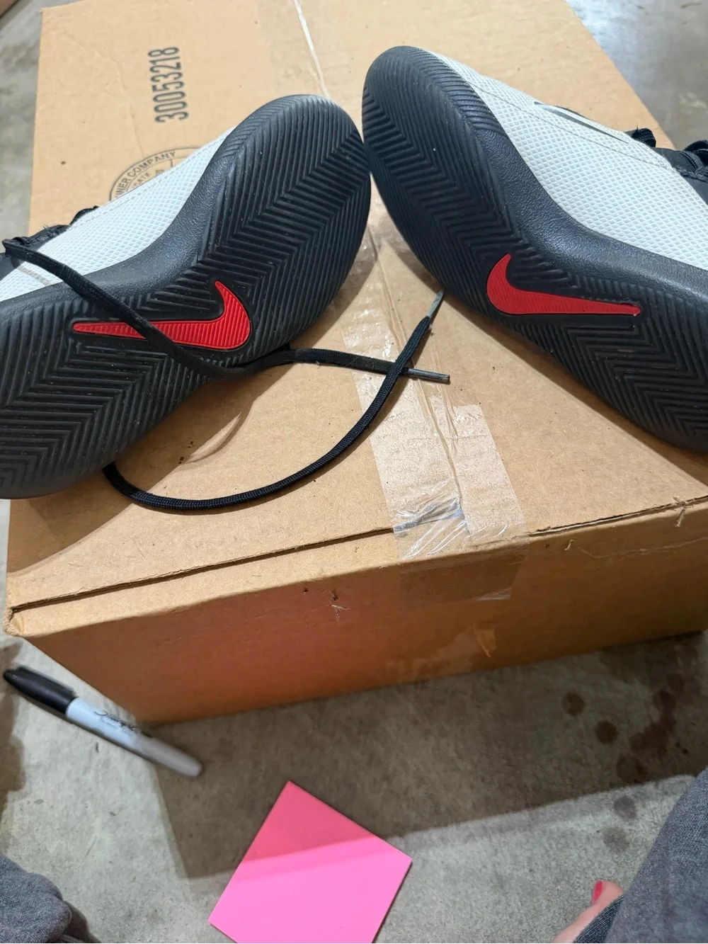 Nike Youth White and Black Athletic Trainers with Red Pull Tabs